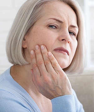 White-haired woman with tooth pain; dental emergency in Virginia Beach, VA